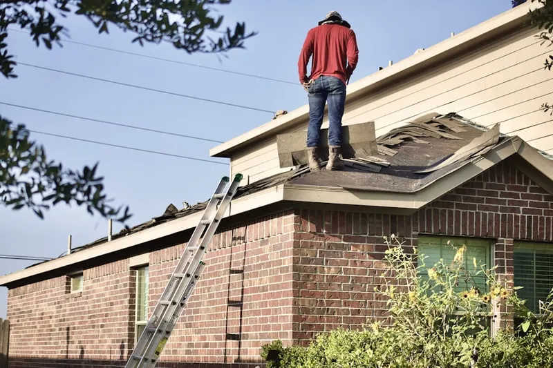 Professional roofer working on a residential roof in Cabin John Park